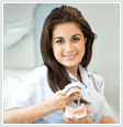 Image of woman holding dentures